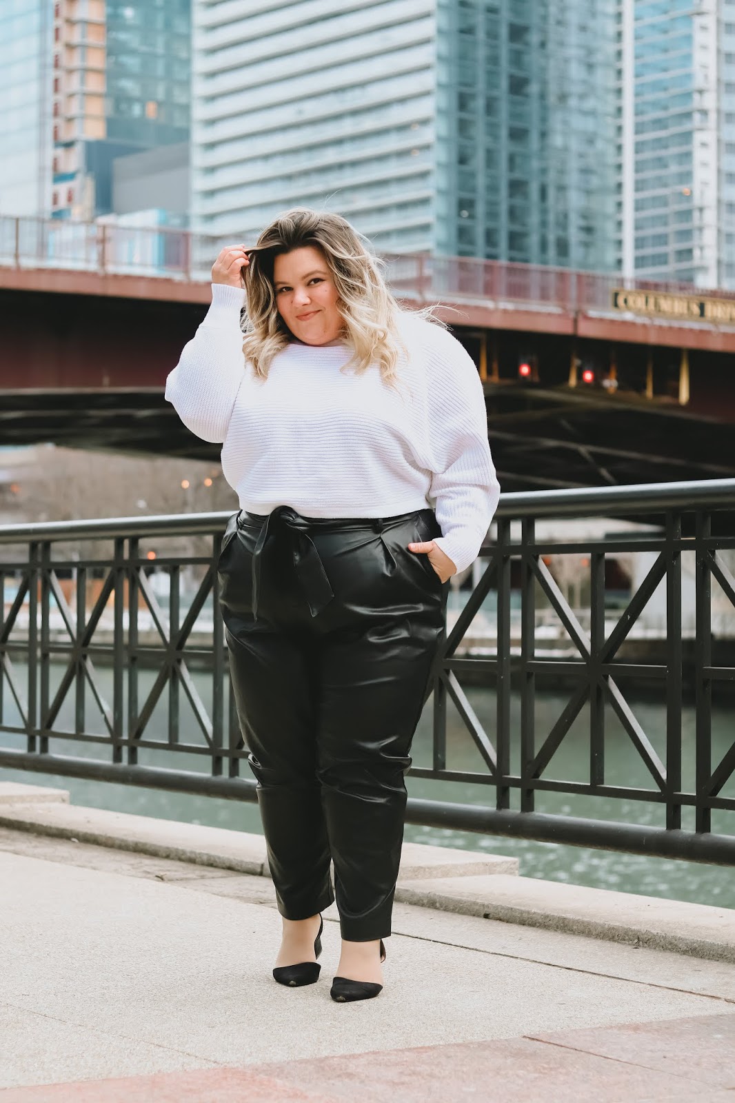 Chicago Plus Size Petite Fashion Blogger]Natalie in the City reviews Eloquii's Pleat Front Faux Leather Ankle Pants and White Cropped Sweater.