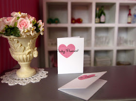 Modern one-twelfth scale miniature bar with urn of roses and wine lists with 'Pinky Promise' on the fronts.