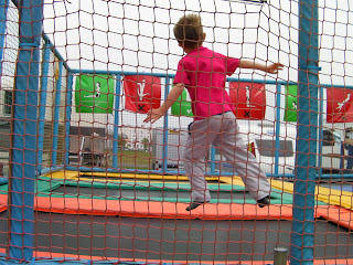boy in mid air over trampoline trampolining at the fairground southsea seafront