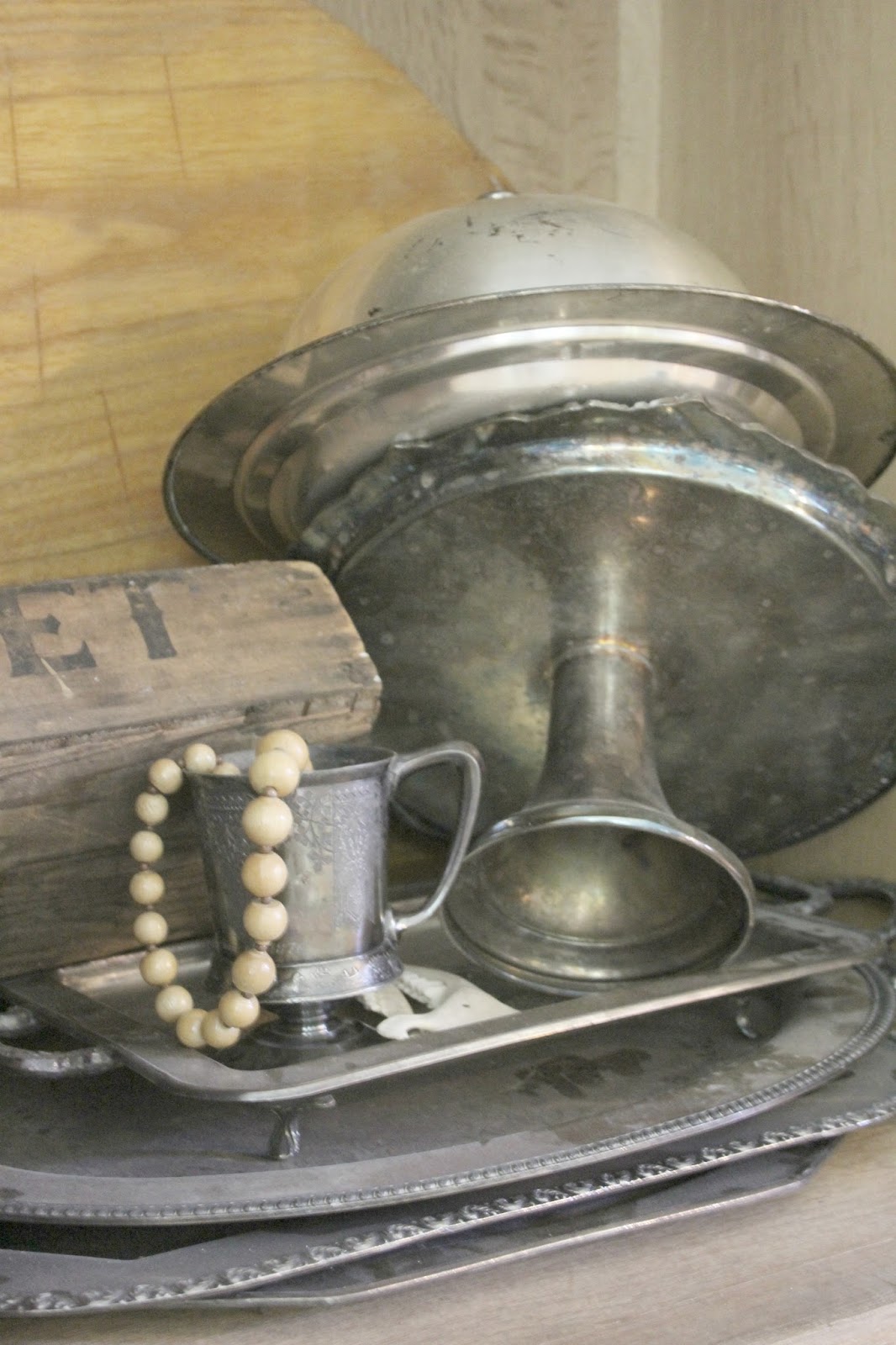 Antique silver pieces piled in an old cupboard on Hello Lovely Studio