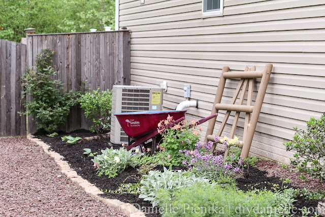 Beautiful garden path with red stone, upcycled wheelbarrow, and columbine. Garden path with red stone, upcycled wheelbarrow, and columbine.