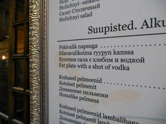 Menu featuring a  'fat plate with a shot of vodka' in Tallinn, Estonia