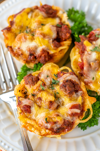 Mini Taco Spaghetti Pies - two favorites combined into one delicious dish!!! Bake in a muffin pan for a fun meal! Spaghetti, eggs, parmesan cheese, ground beef, taco seasoning, Rotel diced tomatoes and green chiles, spaghetti sauce, cottage cheese, butter, cheddar cheese. Can freeze leftovers for a quick meal later. Since they are small, they reheat in a flash! Our new favorite way to eat tacos and spaghetti! #tacos #spaghetti #freezermeal #recipe #spaghettipie #pasta Mini Taco Spaghetti Pies - two favorites combined into one delicious dish!!! Bake in a muffin pan for a fun meal! Spaghetti, eggs, parmesan cheese, ground beef, taco seasoning, Rotel diced tomatoes and green chiles, spaghetti sauce, cottage cheese, butter, cheddar cheese. Can freeze leftovers for a quick meal later. Since they are small, they reheat in a flash! Our new favorite way to eat tacos and spaghetti! #tacos #spaghetti #freezermeal #recipe #spaghettipie #pasta