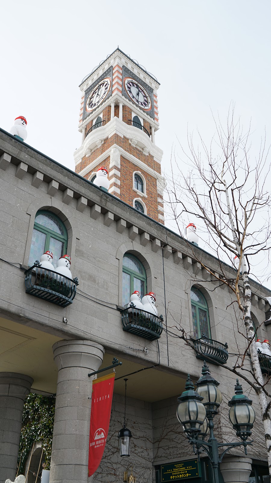 Clock tower with snowmen on the windows and terrace free