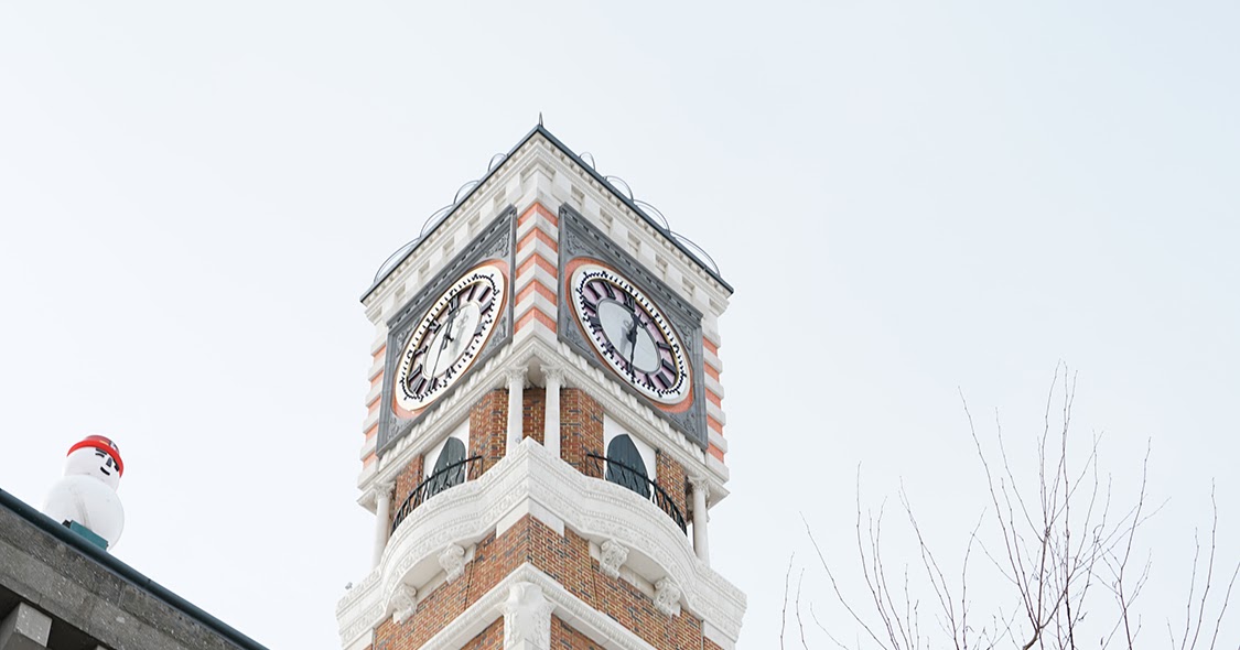 Clock tower with snowmen on the windows and terrace free