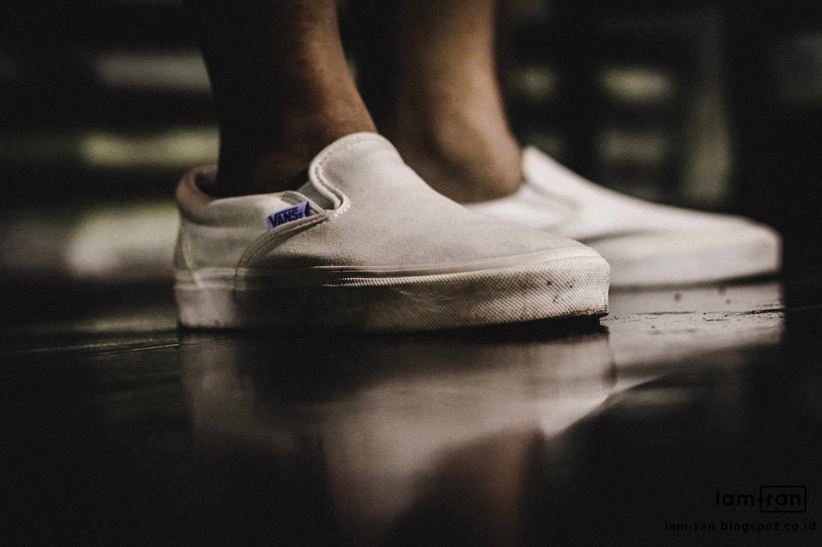 white slip on vans on feet