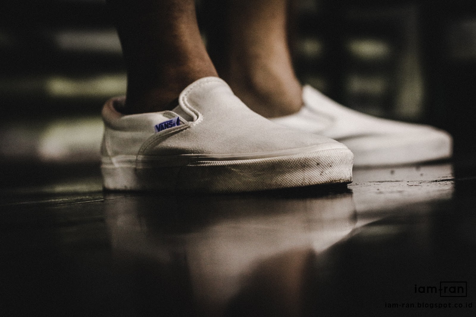 white vans slip ons on feet