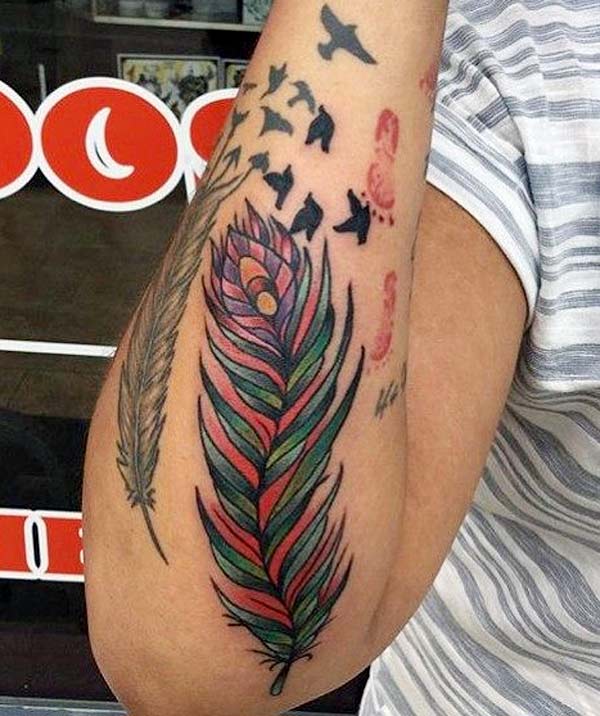 Its a great tattoo ideas for girls forearm black and grey feather and colorful feather tattoo with birds flying away Its a great tattoo ideas for girls forearm black and grey feather and colorful feather tattoo with birds flying away