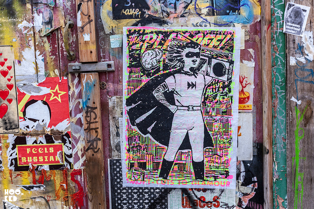 Super hero with boombox, Brick Lane Street Art paste-ups in London by artist Zombiesqueegee Super hero with boombox, Brick Lane Street Art paste-ups in London by artist Zombiesqueegee