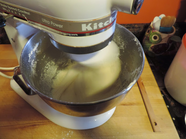 The dough for the homemade dinner rolls being kneaded in the kitchenaid mixer.