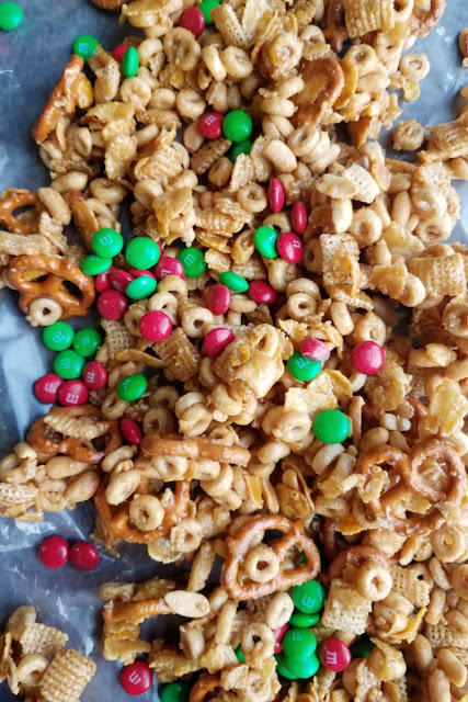 This caramel snack mix has it all. It is sweet and salty, crunchy and delicious. Plus it can easily be customized to what you have on hand or your tastes! sweet and salty snack mix with m&ms mixed in