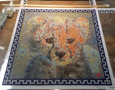 Cheetah cub mosaic portrait, all tiles laid. Ready to be glued on its support.