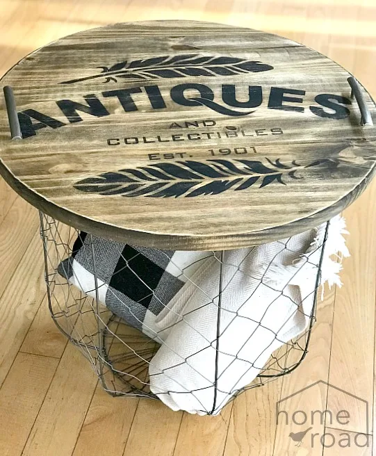 Wooden tray on basket filled with pillows and blankets