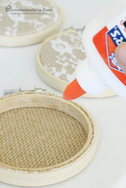 Elmer's glue on the back of hoop to hold the fabric