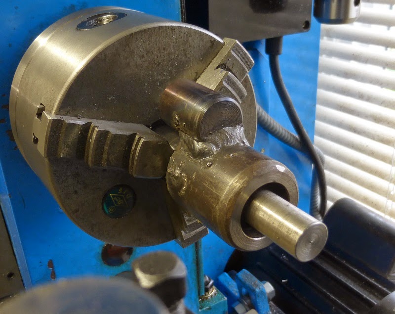 welded burner assembly in lathe ready for machining