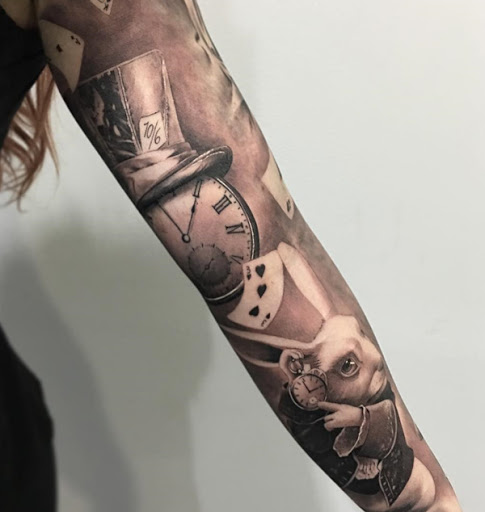 Um pouco de Alice no país das maravilhas inspirado manga da tatuagem. Você pode ver o chapeleiro louco do chapéu, o relógio de bolso, os cartões e o coelho no projeto e isso ajuda a trazer de volta memórias de infância e as maravilhosas aventuras de Alice.