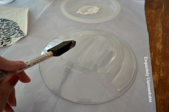 Using a foam brush to add Mod Podge to a glass plate