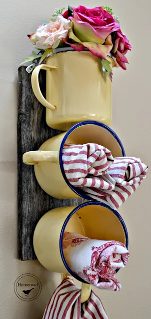 Yellow enamelware mugs filled with fabric napkins