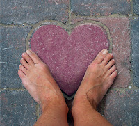 two feet on a purple heart of rock in the stone walkway