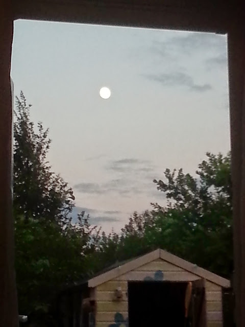 The moon viewed through an upstairs window