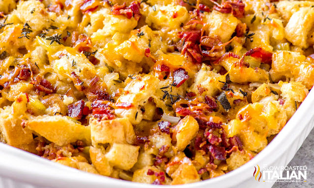 close up image of cheesy bacon casserole in white baking dish