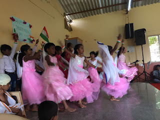 A group of 8 year old girls performing a dance for the school