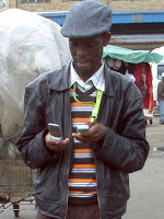 Matlabe juggling 2 cell phones in Maseru