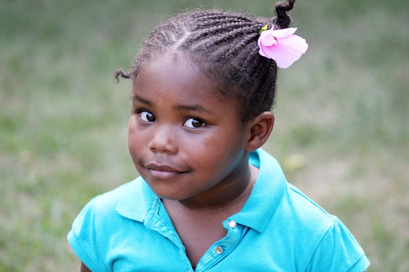NAMC montessori following child through observation. smiling young girl