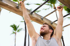 exercise-fitness-athlete-exercising-monkey-bars-crossfit-man-working-out-arms-swinging-brachiation-ladder-as-strength-49488059.jpg