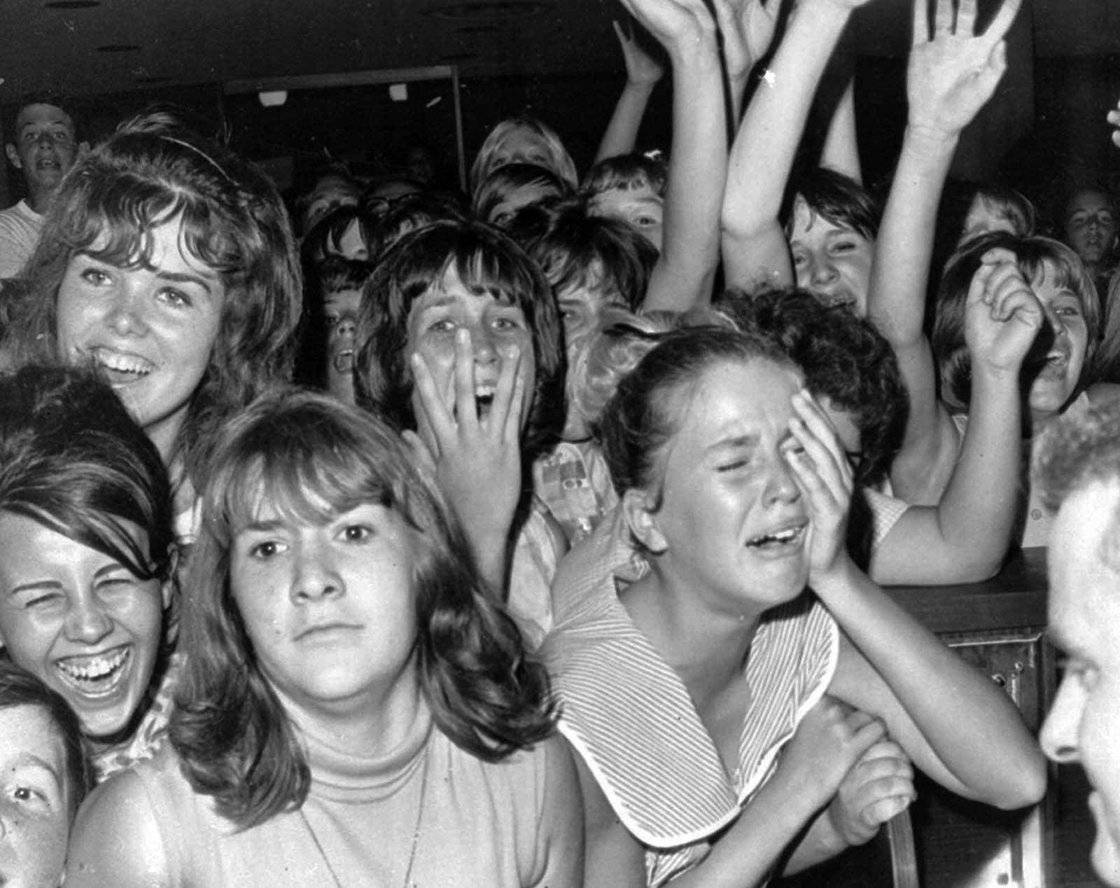 Just the sight of The Beatles from a distance caused this reaction among a group of girls at the Los Angeles International Airport on August 18, 1964. Airport security kept several thousand youngsters away from the British singers during a brief stopover in Los Angeles en route to San Francisco.