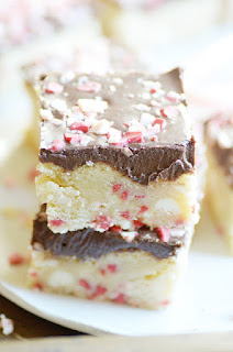 Soft and chewy sugar cookie bars loaded with white chocolate, peppermint bits and topped with fudgy chocolate frosting.