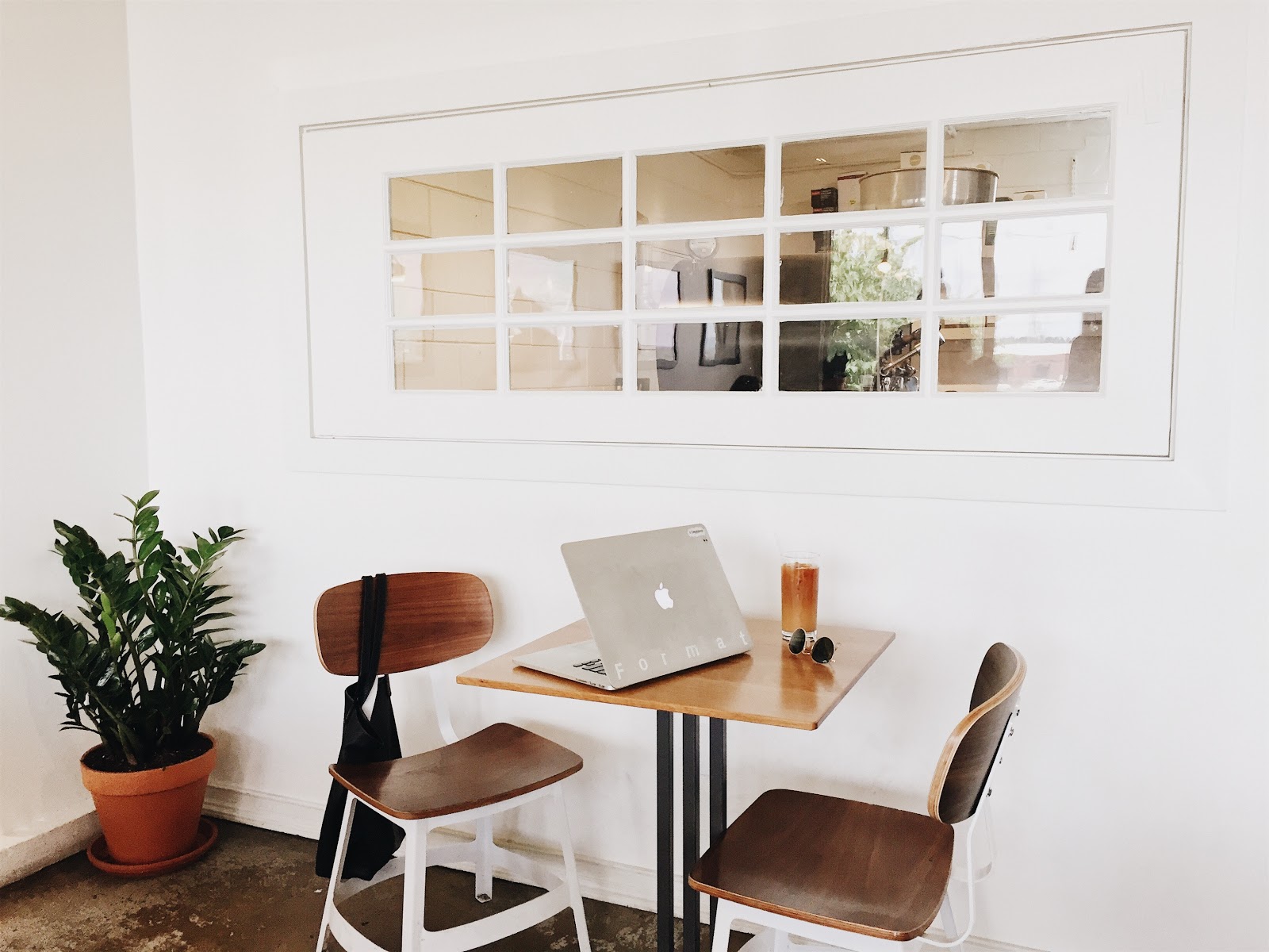 Macbook on Brown Wooden Dining Table and Chairs Macbook on Brown Wooden Dining Table and Chairs