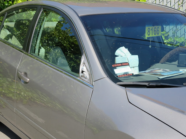 2012 Nissan Altima door damage from hitting edge of mirror