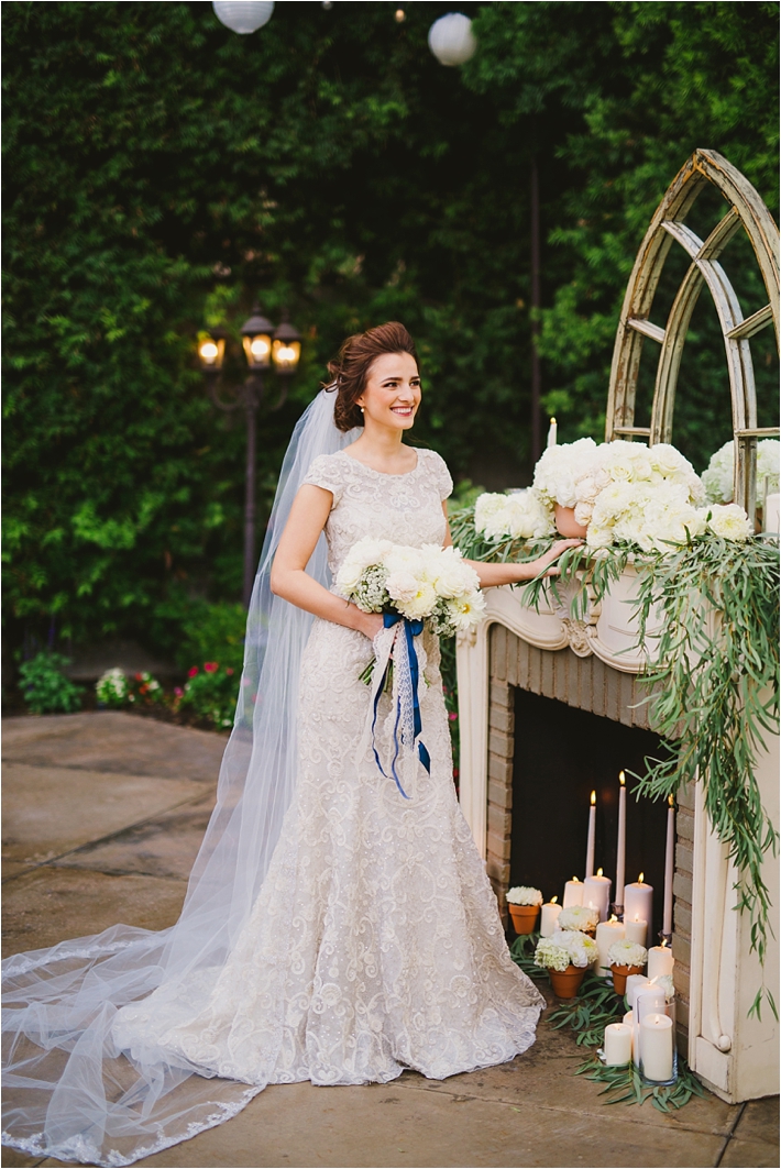 Elegant bride in lace gown in front of altar // Photo by Closer to Love Photography via @thesocalbride