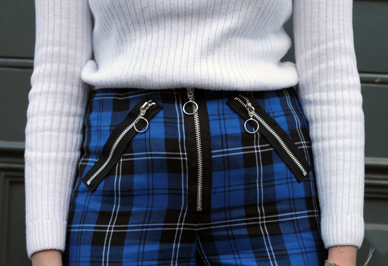 blue tartan kick flare trousers with black ring pull zips
