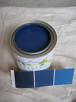Can of Benjamin Moore Deep Royal blue with paint swatches