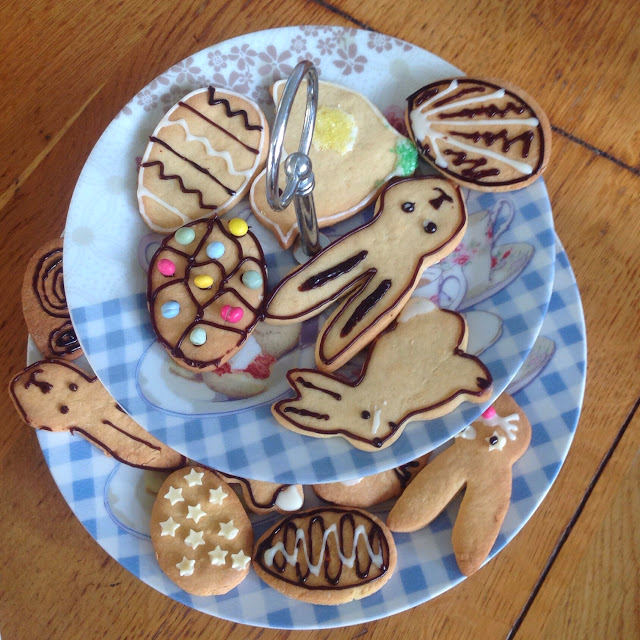 making biscuits plate of easter themed decorated cookies