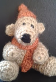 http://www.ravelry.com/patterns/library/free-pattern---teddy-bear-with-a-bobble-hat-and-scarf