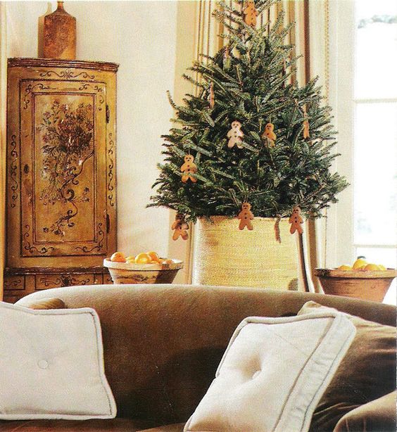 Pamela Pierce designed living room with live tree decorated with gingerbread cookies for Christmas.