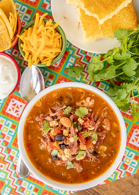 Pulled Pork Taco Soup - the BEST taco soup EVER!!! Pulled pork, pinto beans, black beans, diced tomatoes and green chiles, corn, taco seasoning, ranch seasoning, chicken broth. SO easy to make. Just dump everything in the pot, bring to a boil and simmer. Can also make in the #slowcooker. Great for tailgating and potlucks. Can freeze leftovers for a quick meal later. Our favorite taco soup recipe! #soup #taco #pulledpork Pulled Pork Taco Soup - the BEST taco soup EVER!!! Pulled pork, pinto beans, black beans, diced tomatoes and green chiles, corn, taco seasoning, ranch seasoning, chicken broth. SO easy to make. Just dump everything in the pot, bring to a boil and simmer. Can also make in the #slowcooker. Great for tailgating and potlucks. Can freeze leftovers for a quick meal later. Our favorite taco soup recipe! #soup #taco #pulledpork