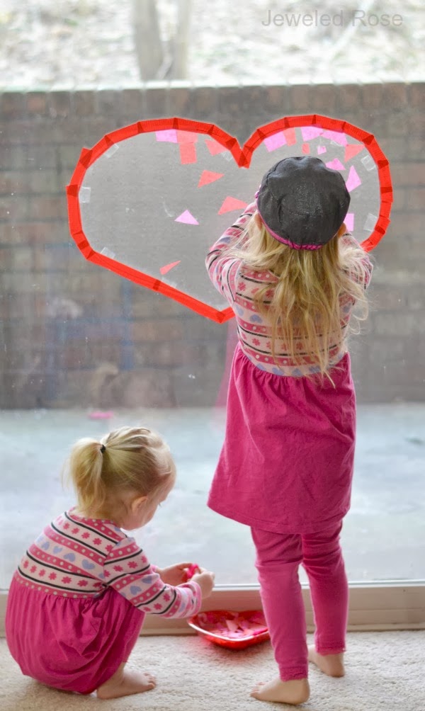 HEART SUN CATCHER CRAFT: these looked beautiful hanging in our windows! #craftsforkids #valentinesdaycrafts #suncatchers