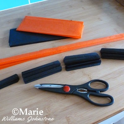 Black and orange tissue papers folded up and cut to size
