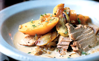 Classic dish of pork braised in cider served sliced with new potatoes and apples and dressed with a cream and cider sauce