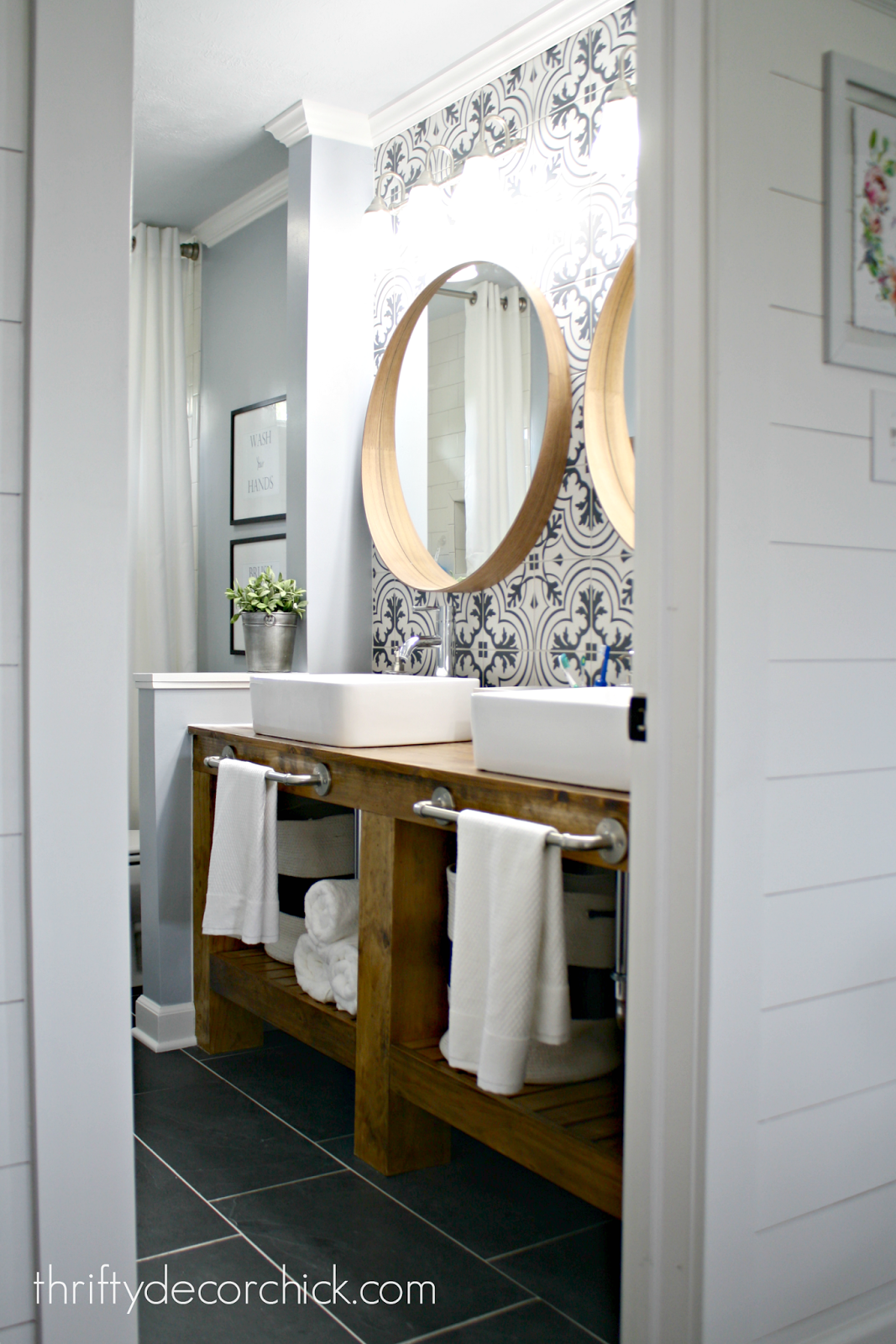 wood bathroom vanity with patterned backsplash wall