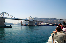 Porta de Europa Bridge as seen from sightseeing boat in Barcelona harbor