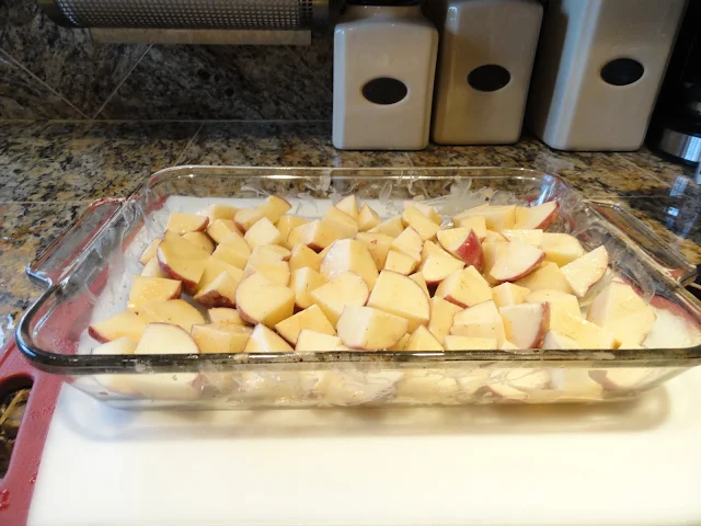 10 Red Potatoes cut into bite sized pieces in a glass pan.
