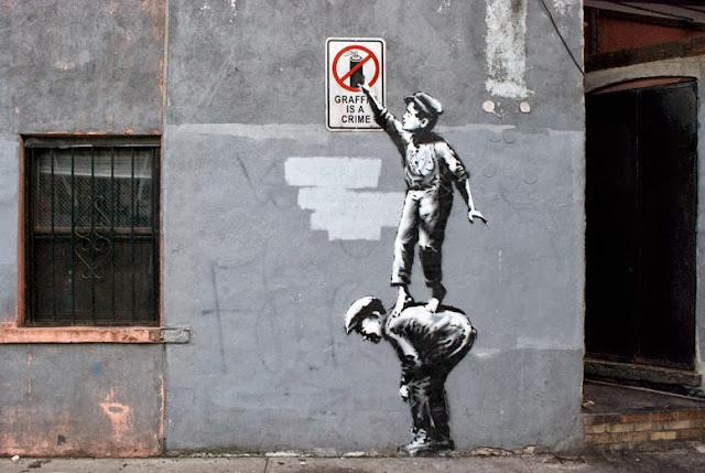 Street Art By Banksy In Chinatown, New York City, USA "Better Out Than In" October 2013.