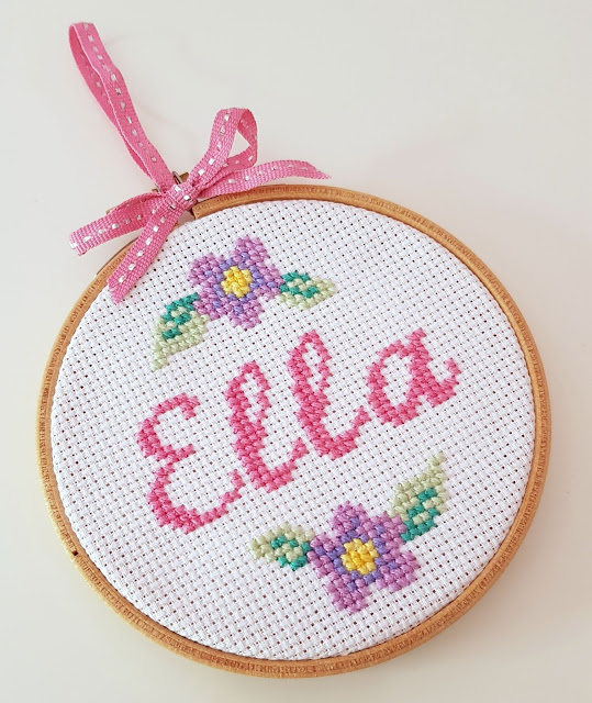 Baby name cross-stitch in an embroidery hoop