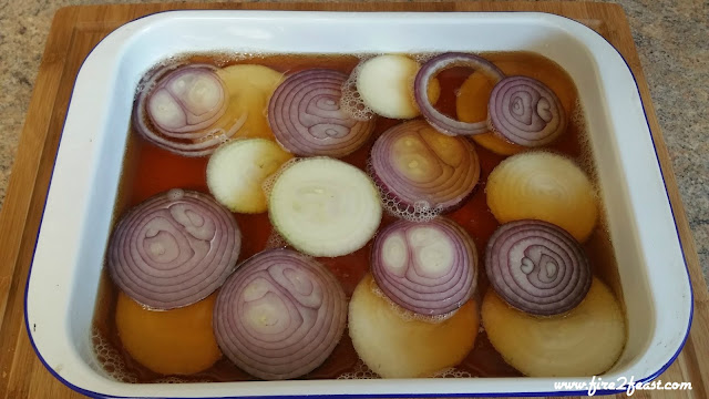 pan with onions half filled with beer