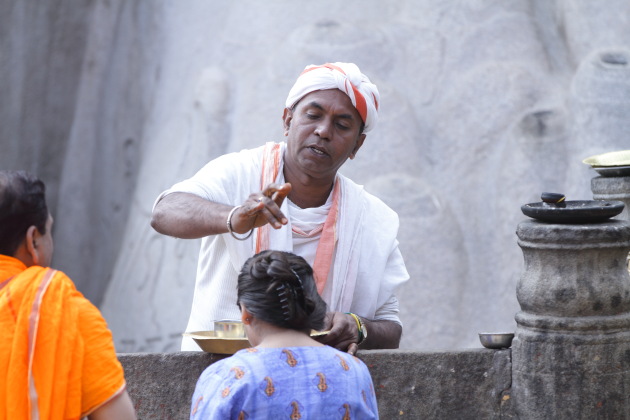 Jain priest giving blessings to devotee at Shravanabelagola, Karnataka